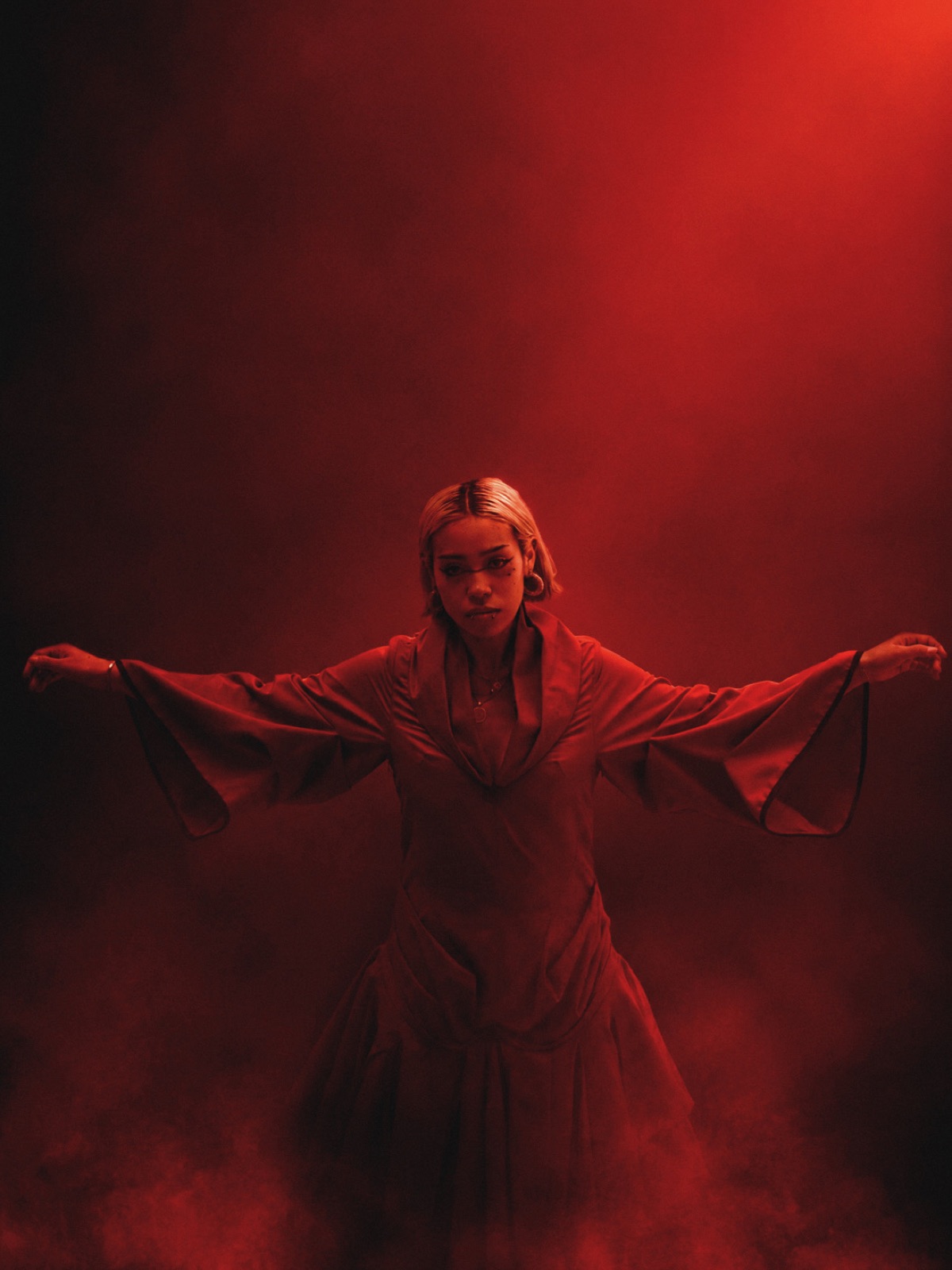 Ashalys, bras ouverts, dans une brume rouge